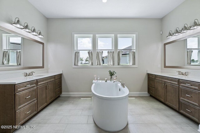 105 Awlleaf Ct, Saint Augustine, FL 32095 - bathroom with two vanities, a freestanding tub, and tile patterned flooring
