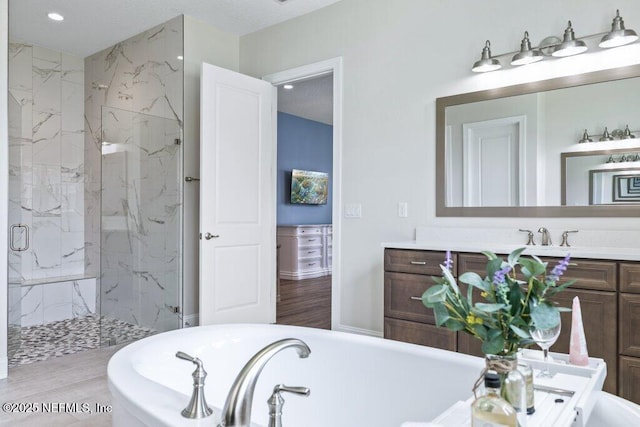 105 Awlleaf Ct, Saint Augustine, FL 32095 - bathroom with vanity, a tub to relax in, a marble finish shower, recessed lighting, and wood finished floors