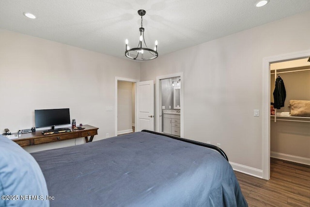 105 Awlleaf Ct, Saint Augustine, FL 32095 - bedroom featuring a chandelier, dark wood finished floors, a spacious closet, a closet, and ensuite bathroom