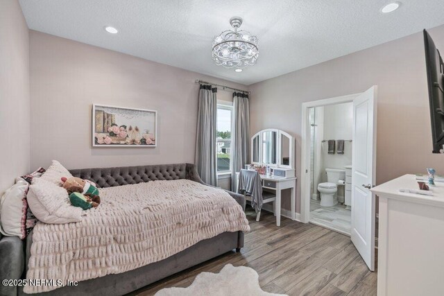 105 Awlleaf Ct, Saint Augustine, FL 32095 - bedroom with light wood-style floors, ensuite bathroom, a textured ceiling, a chandelier, and recessed lighting