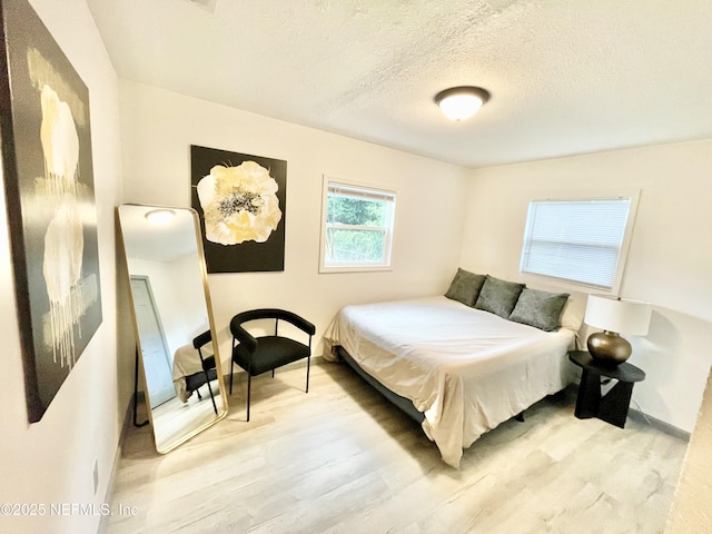 7381 Fernandina Ave, Jacksonville, FL 32208 - bedroom with wood finished floors, baseboards, and a textured ceiling