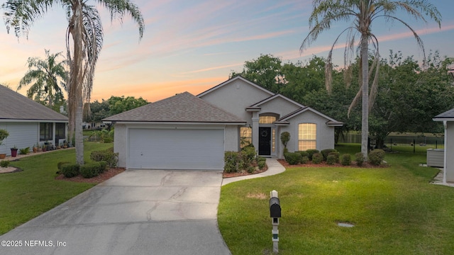 1608 Rustling Dr, Fleming Island, FL 32003 - single story home featuring stucco siding, a garage, driveway, and roof with shingles