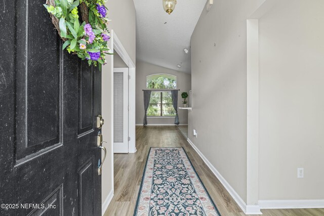 1608 Rustling Dr, Fleming Island, FL 32003 - entrance foyer with wood finished floors, vaulted ceiling, and baseboards