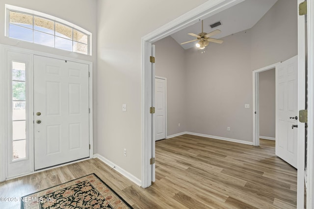 1608 Rustling Dr, Fleming Island, FL 32003 - entryway with light wood-style flooring, high vaulted ceiling, a ceiling fan, and baseboards