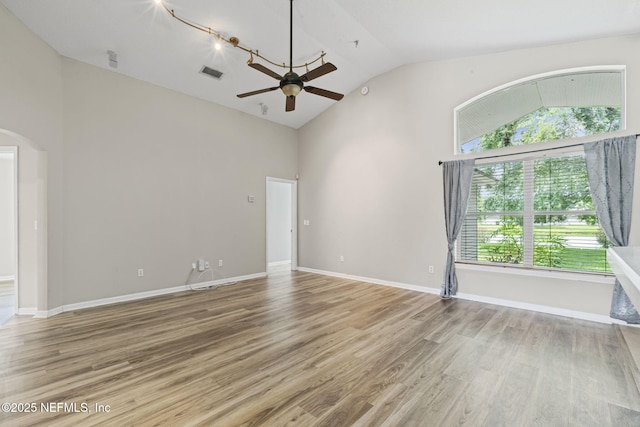 1608 Rustling Dr, Fleming Island, FL 32003 - spare room with ceiling fan, arched walkways, light wood-type flooring, high vaulted ceiling, and baseboards