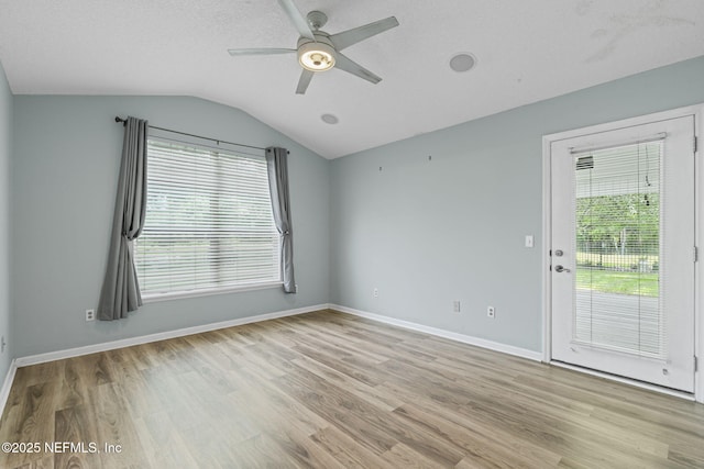 1608 Rustling Dr, Fleming Island, FL 32003 - unfurnished room featuring ceiling fan, plenty of natural light, lofted ceiling, light wood-style floors, and baseboards