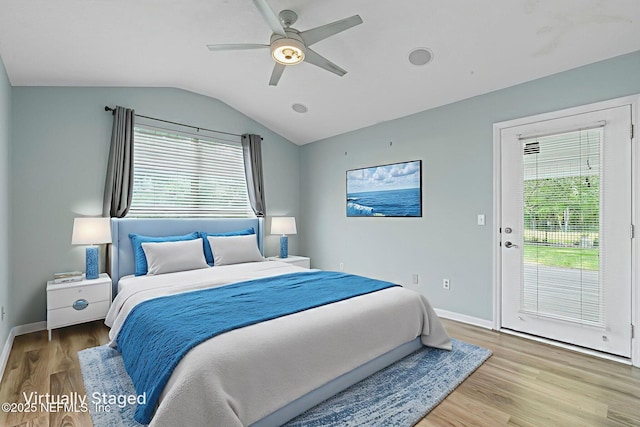 1608 Rustling Dr, Fleming Island, FL 32003 - bedroom with multiple windows, vaulted ceiling, wood finished floors, baseboards, and access to exterior