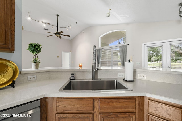 1608 Rustling Dr, Fleming Island, FL 32003 - kitchen with a sink, stainless steel dishwasher, healthy amount of natural light, vaulted ceiling, and rail lighting