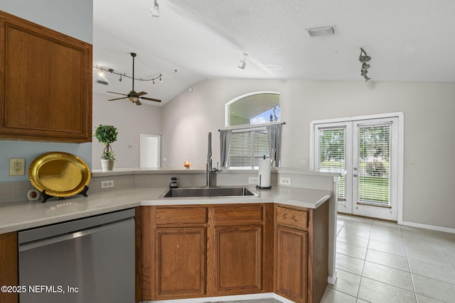 1608 Rustling Dr, Fleming Island, FL 32003 - kitchen featuring stainless steel dishwasher, a sink, lofted ceiling, rail lighting, and light countertops