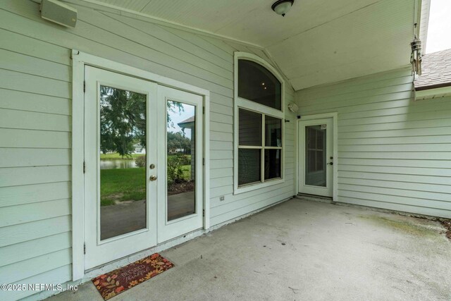1608 Rustling Dr, Fleming Island, FL 32003 - entrance to property with a patio area, french doors, and a water view