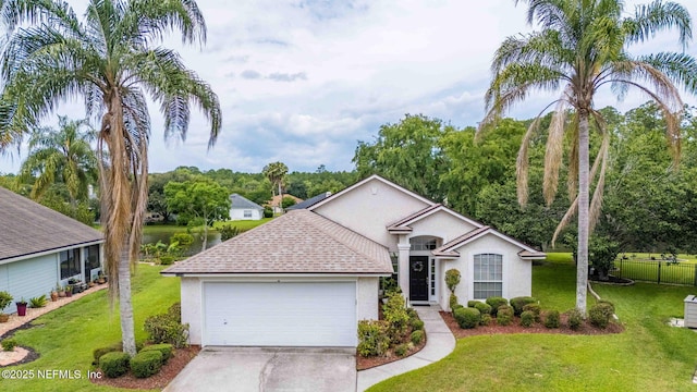 1608 Rustling Dr, Fleming Island, FL 32003 - ranch-style house with stucco siding, an attached garage, concrete driveway, a shingled roof, and a water view