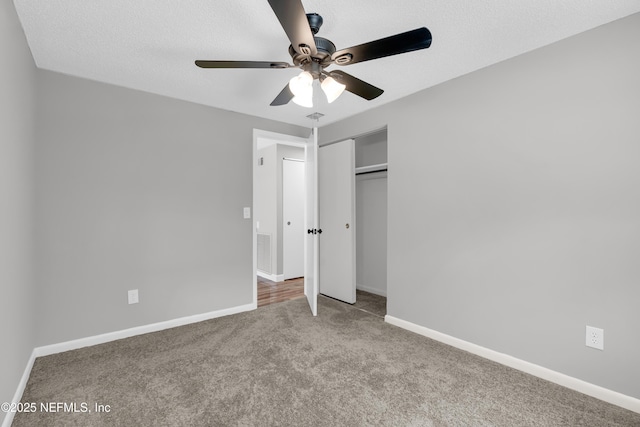 8687 Bishopswood Dr, Jacksonville, FL 32244 - unfurnished bedroom featuring carpet flooring, a closet, a ceiling fan, and a textured ceiling