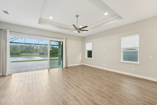 68 Briar Ridge Ct, Ponte Vedra, FL 32081 - empty room with a raised ceiling, wood finished floors, healthy amount of natural light, and recessed lighting