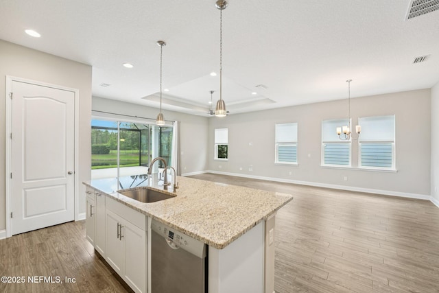 68 Briar Ridge Ct, Ponte Vedra, FL 32081 - kitchen featuring stainless steel dishwasher, light wood-style flooring, a tray ceiling, a chandelier, and a center island with sink
