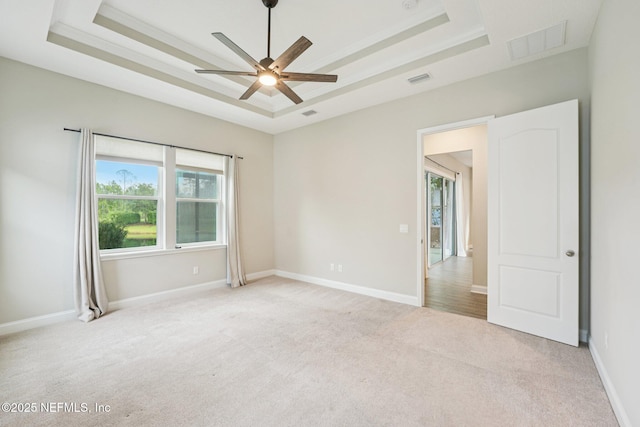 68 Briar Ridge Ct, Ponte Vedra, FL 32081 - spare room featuring a tray ceiling, light colored carpet, and ceiling fan