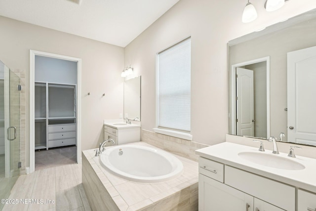 68 Briar Ridge Ct, Ponte Vedra, FL 32081 - full bath featuring a stall shower, two vanities, a garden tub, and a spacious closet
