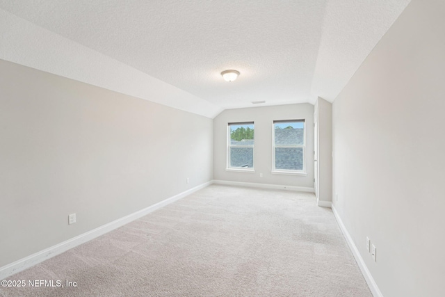 68 Briar Ridge Ct, Ponte Vedra, FL 32081 - unfurnished room featuring vaulted ceiling, light carpet, and a textured ceiling