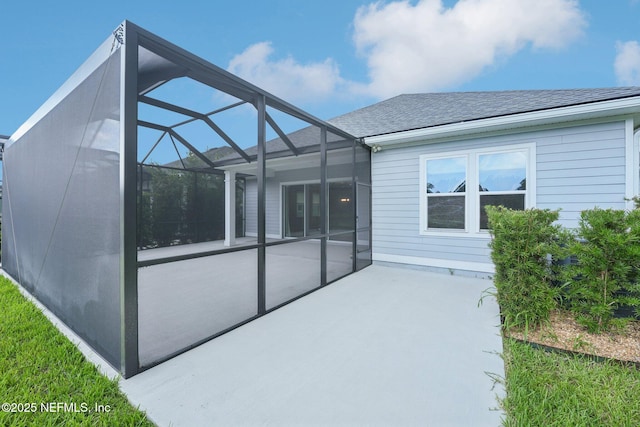 68 Briar Ridge Ct, Ponte Vedra, FL 32081 - back of property featuring a patio area, a shingled roof, and glass enclosure
