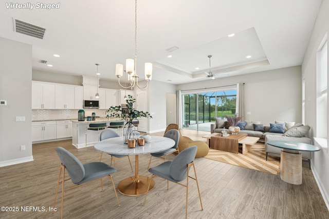 68 Briar Ridge Ct, Ponte Vedra, FL 32081 - dining area featuring light wood-type flooring, a tray ceiling, recessed lighting, and a ceiling fan