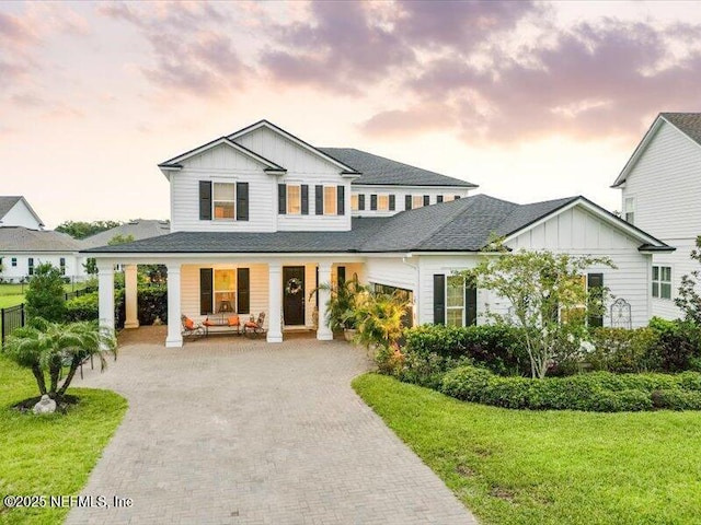 37 Permit Ct, Saint Augustine, FL 32092 - modern farmhouse style home featuring board and batten siding, covered porch, decorative driveway, and a shingled roof