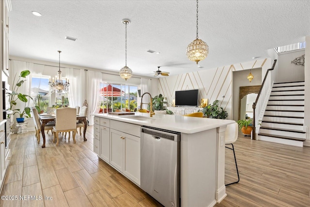 37 Permit Ct, Saint Augustine, FL 32092 - kitchen with stainless steel appliances, a chandelier, ceiling fan, light countertops, and light wood finished floors