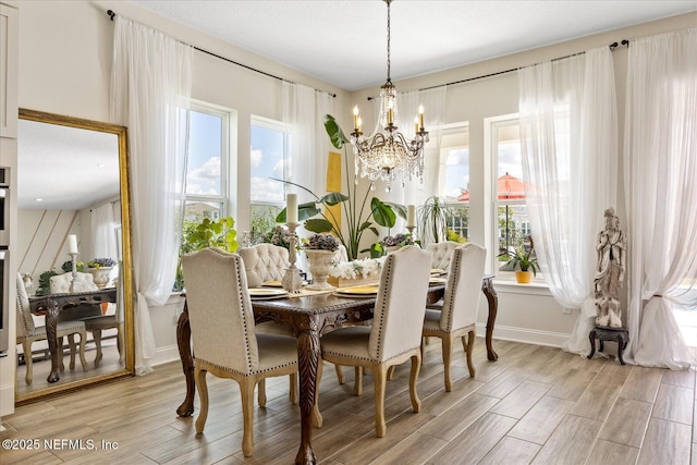 37 Permit Ct, Saint Augustine, FL 32092 - dining area with a chandelier and light wood finished floors