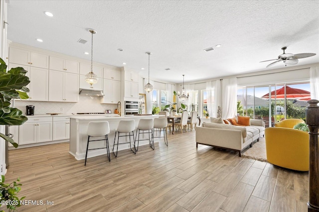 37 Permit Ct, Saint Augustine, FL 32092 - living room with light wood finished floors, recessed lighting, a textured ceiling, and ceiling fan