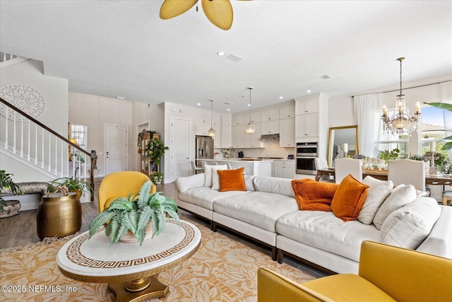 37 Permit Ct, Saint Augustine, FL 32092 - living room with a chandelier, stairway, ceiling fan, light wood-style floors, and recessed lighting