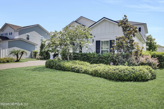 37 Permit Ct, Saint Augustine, FL 32092 - view of front facade with board and batten siding, a front lawn, and decorative driveway