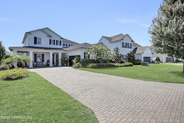 37 Permit Ct, Saint Augustine, FL 32092 - view of front of house featuring decorative driveway, an attached garage, a front lawn, a porch, and board and batten siding