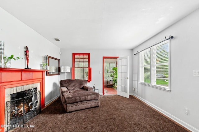 433 W 70th St, Jacksonville, FL 32208 - living room with a tiled fireplace, carpet, and french doors
