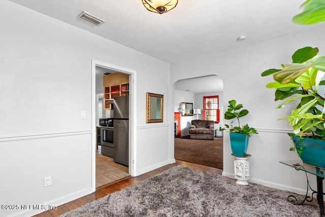 433 W 70th St, Jacksonville, FL 32208 - hallway with arched walkways and wood finished floors