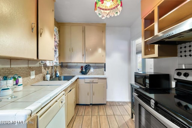 433 W 70th St, Jacksonville, FL 32208 - kitchen with stainless steel electric range oven, tile counters, dishwasher, ventilation hood, and backsplash