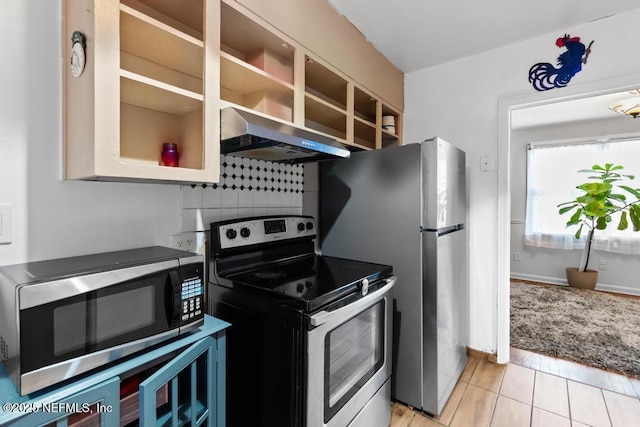 433 W 70th St, Jacksonville, FL 32208 - kitchen with appliances with stainless steel finishes, ventilation hood, light tile patterned floors, and tasteful backsplash