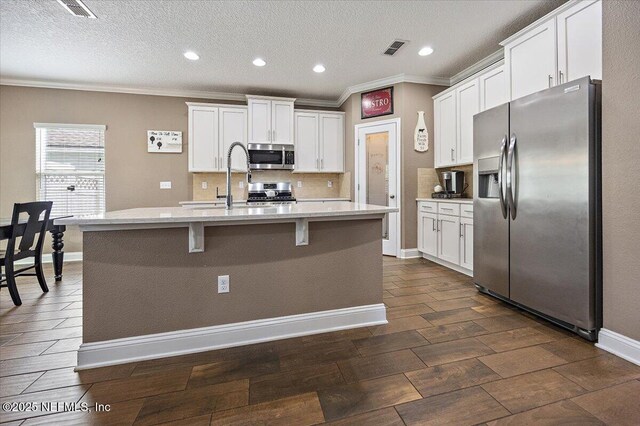795 Shetland Dr, Saint Johns, FL 32259 - kitchen featuring stainless steel appliances, crown molding, backsplash, white cabinetry, and dark wood-style floors