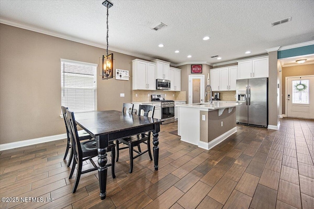 795 Shetland Dr, Saint Johns, FL 32259 - dining room with crown molding, dark wood-style floors, a textured ceiling, recessed lighting, and a chandelier