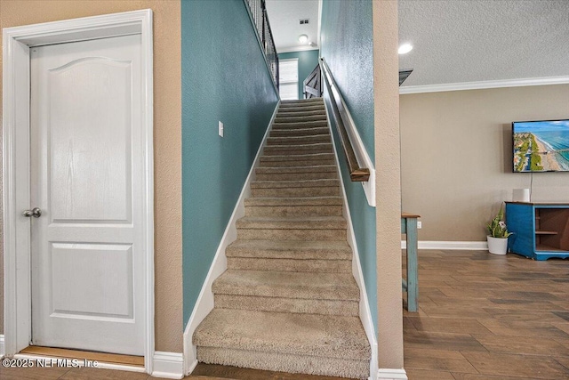 795 Shetland Dr, Saint Johns, FL 32259 - staircase featuring ornamental molding, wood finished floors, a textured ceiling, and a textured wall