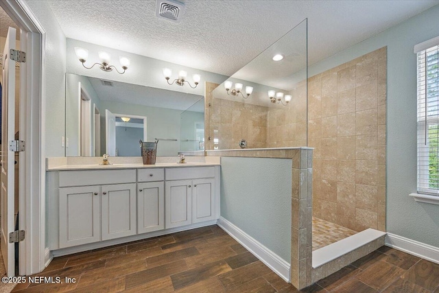 795 Shetland Dr, Saint Johns, FL 32259 - full bath featuring wood finished floors, double vanity, a walk in shower, a textured ceiling, and recessed lighting