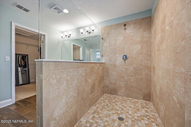 795 Shetland Dr, Saint Johns, FL 32259 - bathroom with a walk in shower, a textured ceiling, and a spacious closet