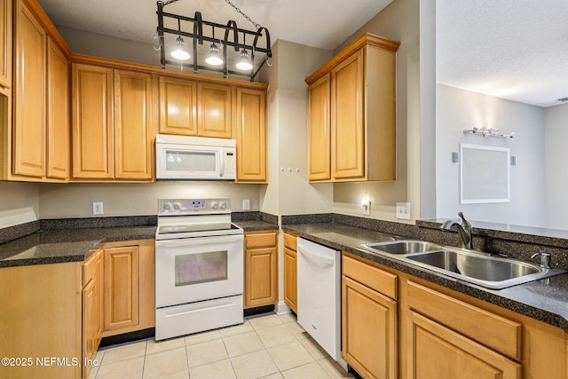 8601 Beach Blvd Unit 507, Jacksonville, FL 32216 - kitchen with white appliances, a sink, light tile patterned flooring, and dark countertops
