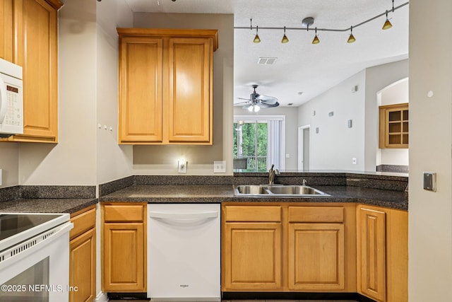8601 Beach Blvd Unit 507, Jacksonville, FL 32216 - kitchen with white appliances, a sink, ceiling fan, dark countertops, and rail lighting
