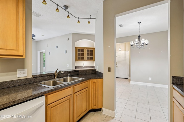 8601 Beach Blvd Unit 507, Jacksonville, FL 32216 - kitchen featuring dishwasher, a sink, light tile patterned floors, dark countertops, and a textured ceiling
