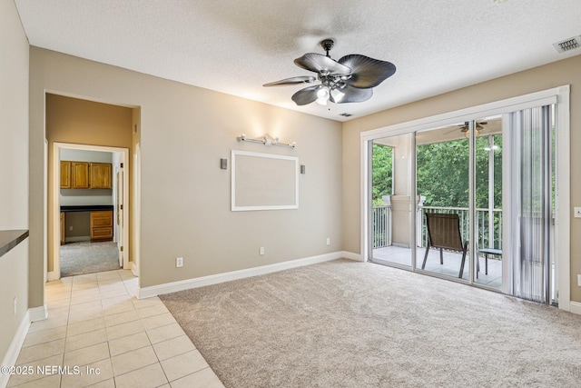8601 Beach Blvd Unit 507, Jacksonville, FL 32216 - unfurnished room with light carpet, ceiling fan, baseboards, a textured ceiling, and light tile patterned flooring