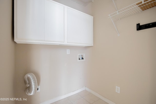 8601 Beach Blvd Unit 507, Jacksonville, FL 32216 - laundry area featuring cabinet space, washer hookup, light tile patterned floors, and baseboards