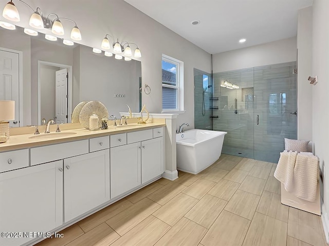 95191 Poplar Way, Fernandina Beach, FL 32034 - full bath featuring double vanity, a soaking tub, a shower stall, and recessed lighting