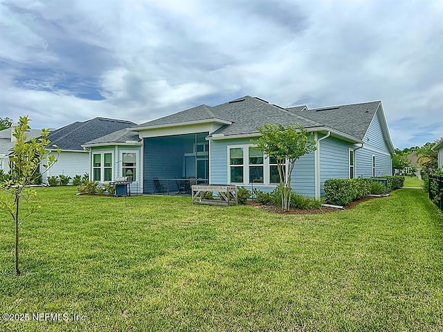 95191 Poplar Way, Fernandina Beach, FL 32034 - rear view of property featuring a yard, a shingled roof, and a sunroom