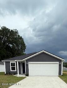 8051 Driggers St, Jacksonville, FL 32220 - ranch-style house featuring concrete driveway and an attached garage