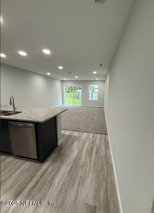 8051 Driggers St, Jacksonville, FL 32220 - kitchen with dishwasher, a sink, light wood-style floors, baseboards, and recessed lighting