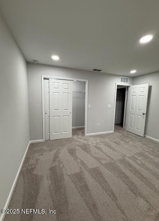 8051 Driggers St, Jacksonville, FL 32220 - unfurnished bedroom featuring baseboards, carpet flooring, recessed lighting, a closet, and a walk in closet