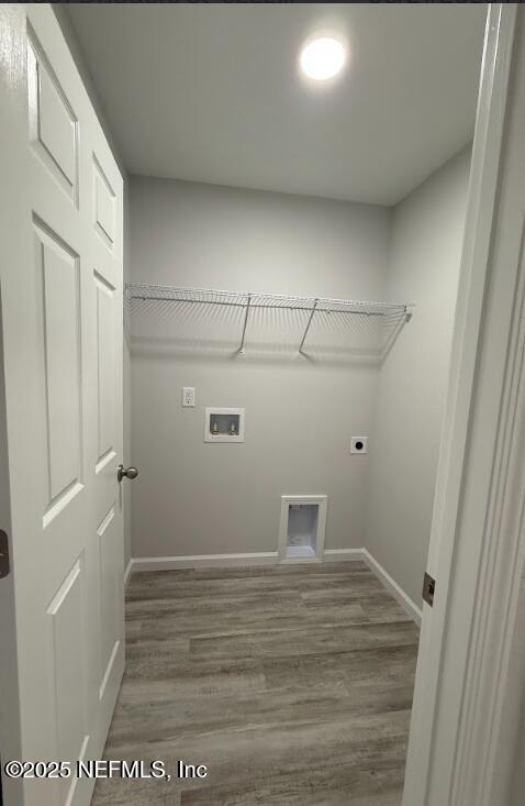 8051 Driggers St, Jacksonville, FL 32220 - laundry room with wood finished floors, hookup for an electric dryer, baseboards, and hookup for a washing machine